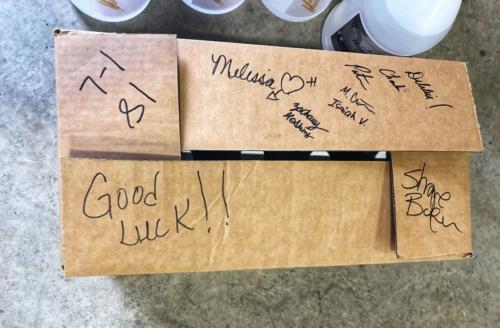 A signed box of hand sanitizer conveys well wishes for the recipients.